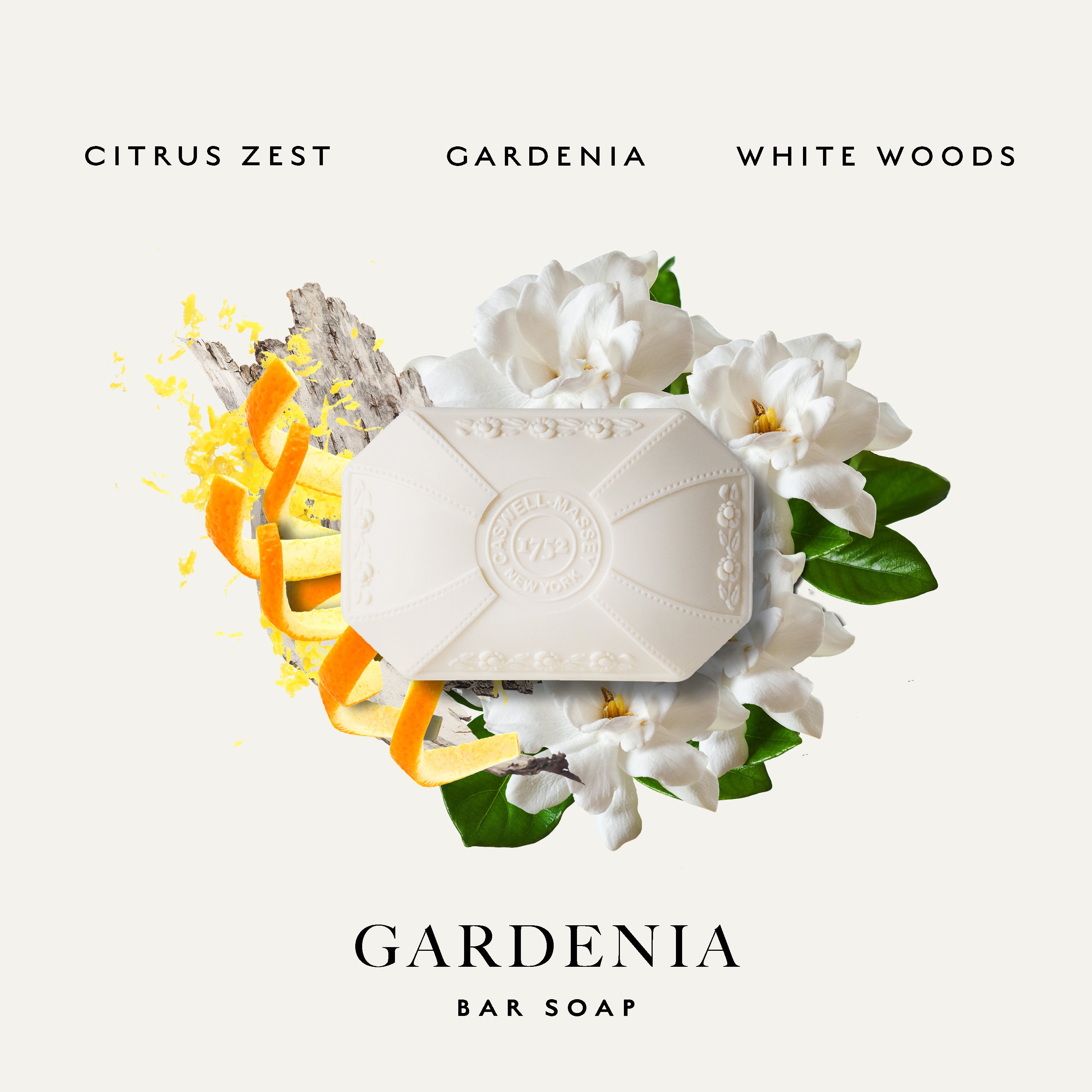 A bar of white Caswell-Massey Gardenia soap centered on a light cream background, surrounded by white flowers, green leaves, and orange citrus zest. Text at the top reads 'CITRUS ZEST GARDENIA WHITE WOODS' and text at the bottom reads 'GARDENIA BAR SOAP'.