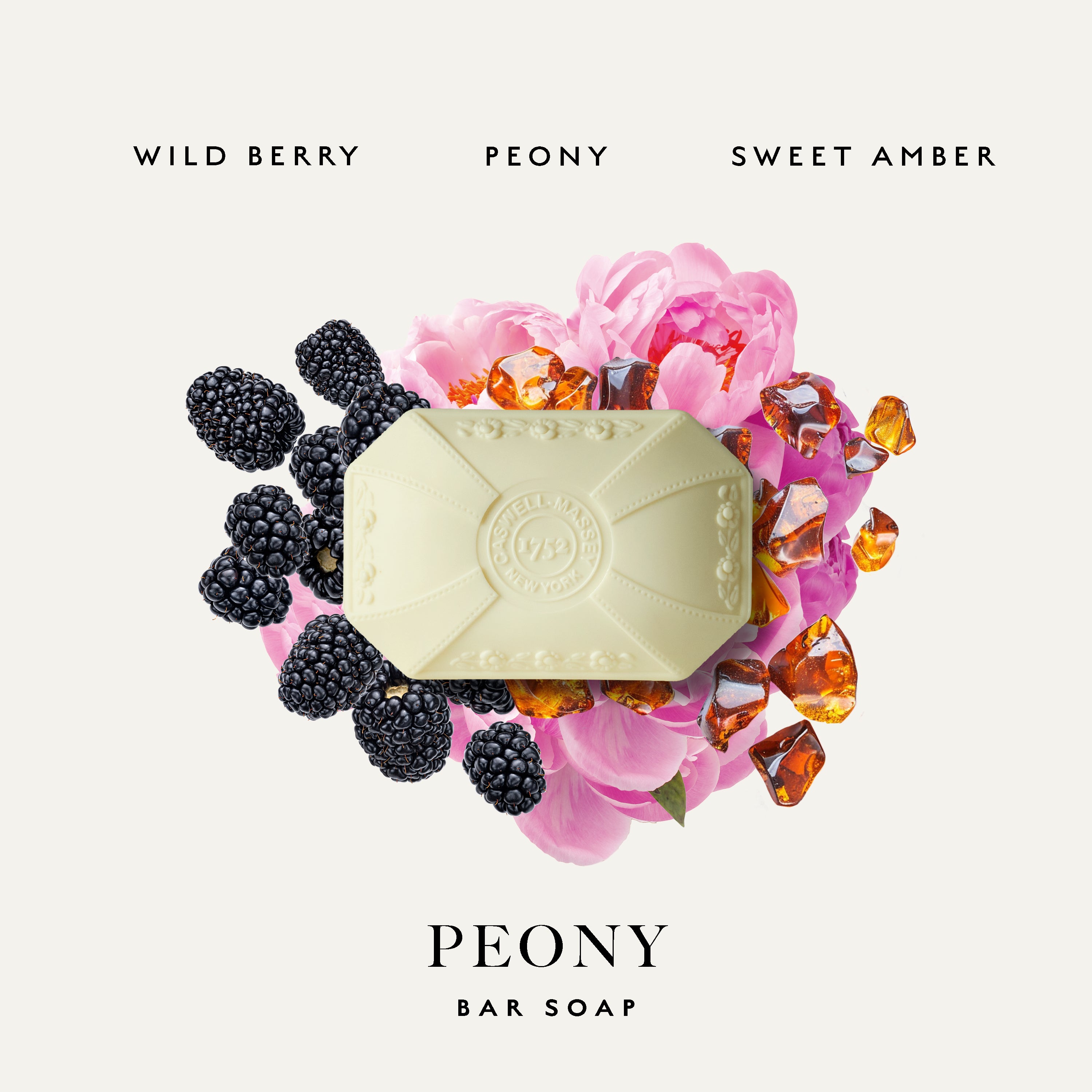 A bar of Caswell-Massey Peony Bar soap centered on a light warm gray background, surrounded by pink flowers, blackberries, and amber-colored gem-like accents. Text above reads 'WILD BERRY PEONY SWEET AMBER' and below reads 'PEONY BAR SOAP'.