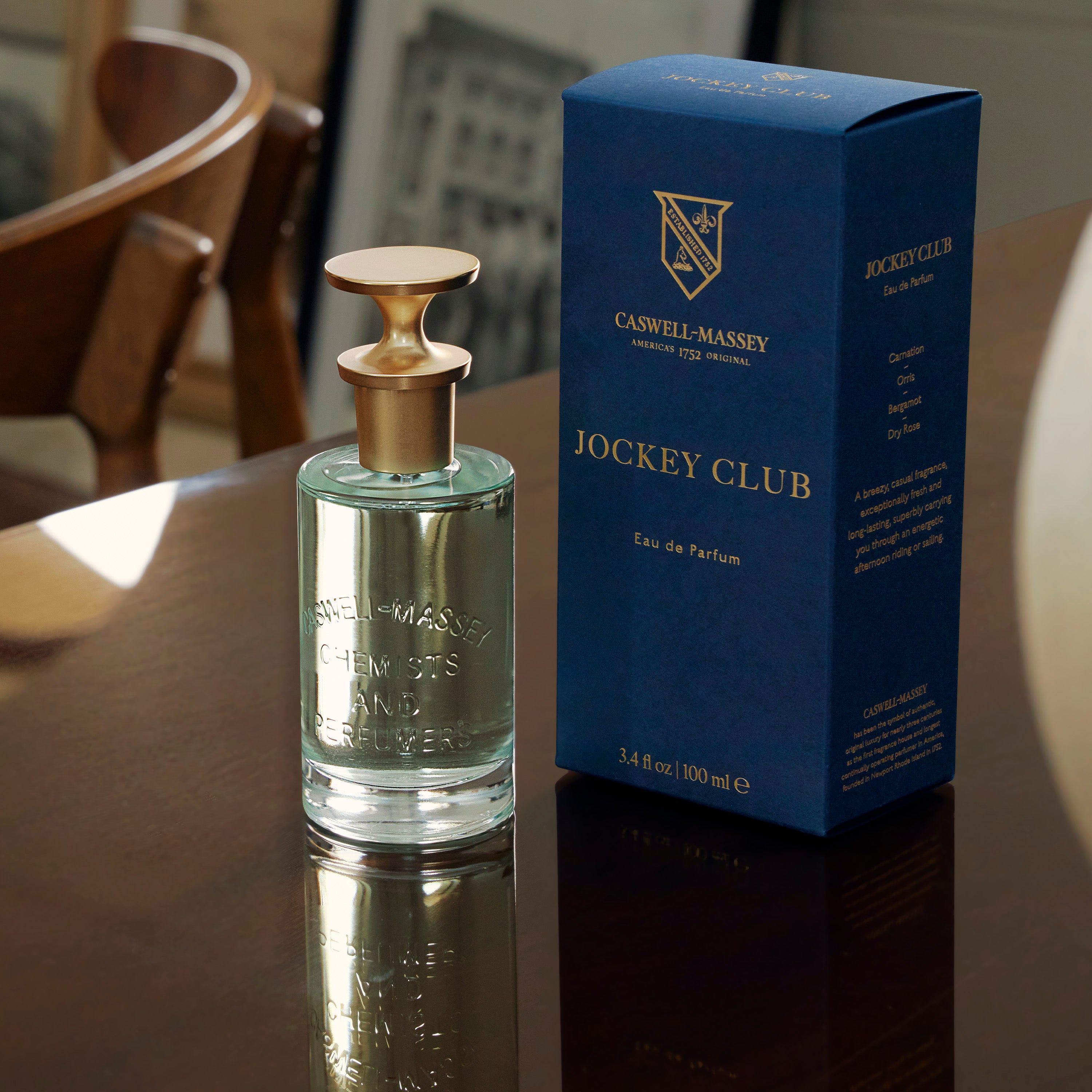 Caswell-Massey Jockey Club Eau de Parfum 100 mL fragrance bottle sitting on dark wood table