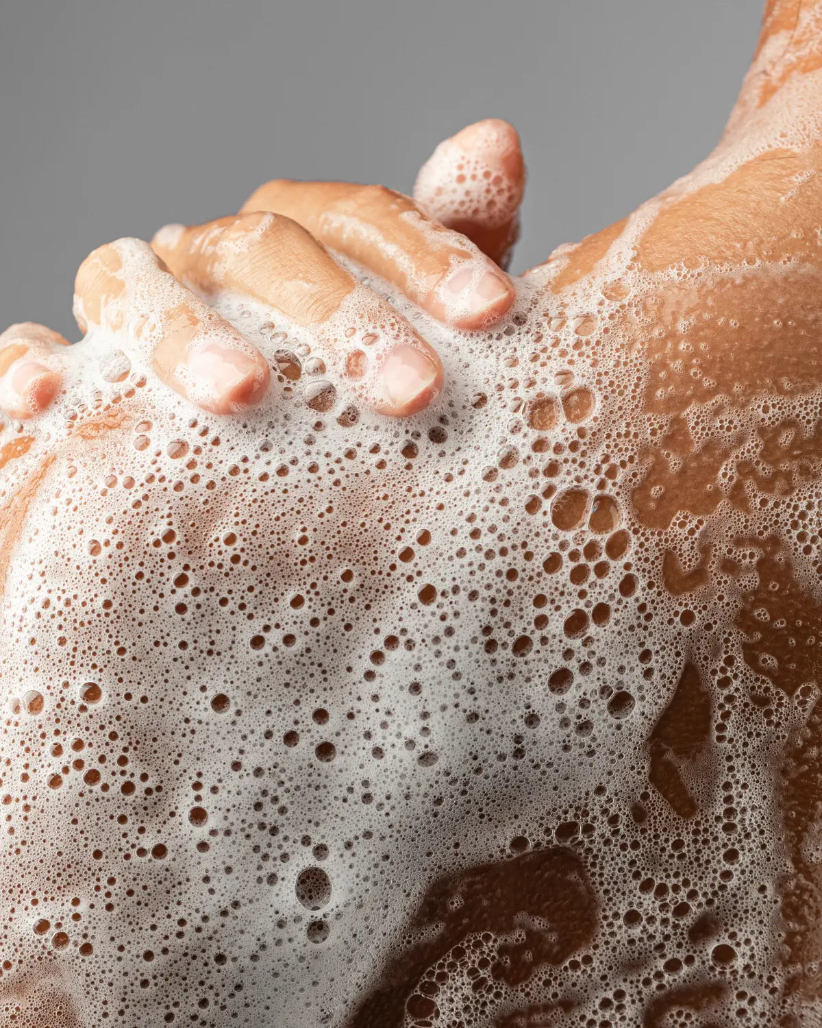 Caswell-Massey Bar Soap: Image shows woman lathering soap suds and washing shoulder.