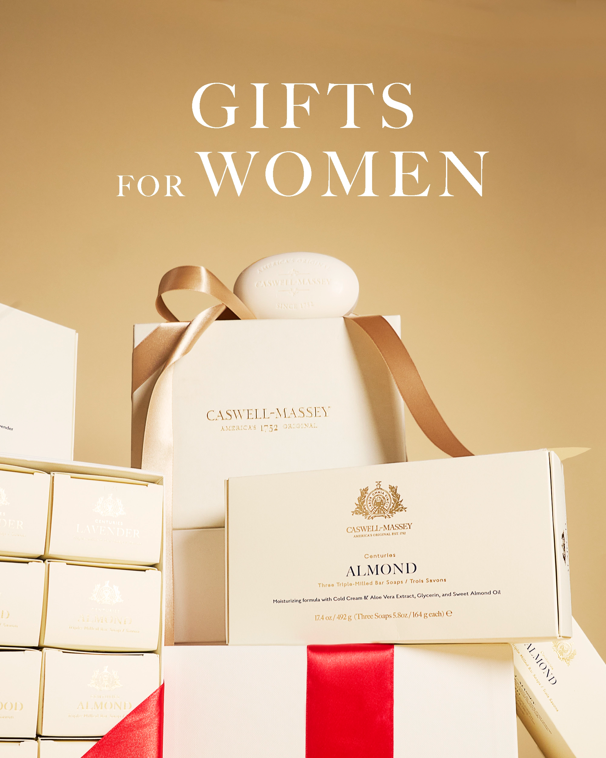 Caswell-Massey Gifts for Women. Image shows close-up of stacked gift boxes in signature cream color. Gift sets include Almond 3-Soap Set and women's Centuries Gift Set.