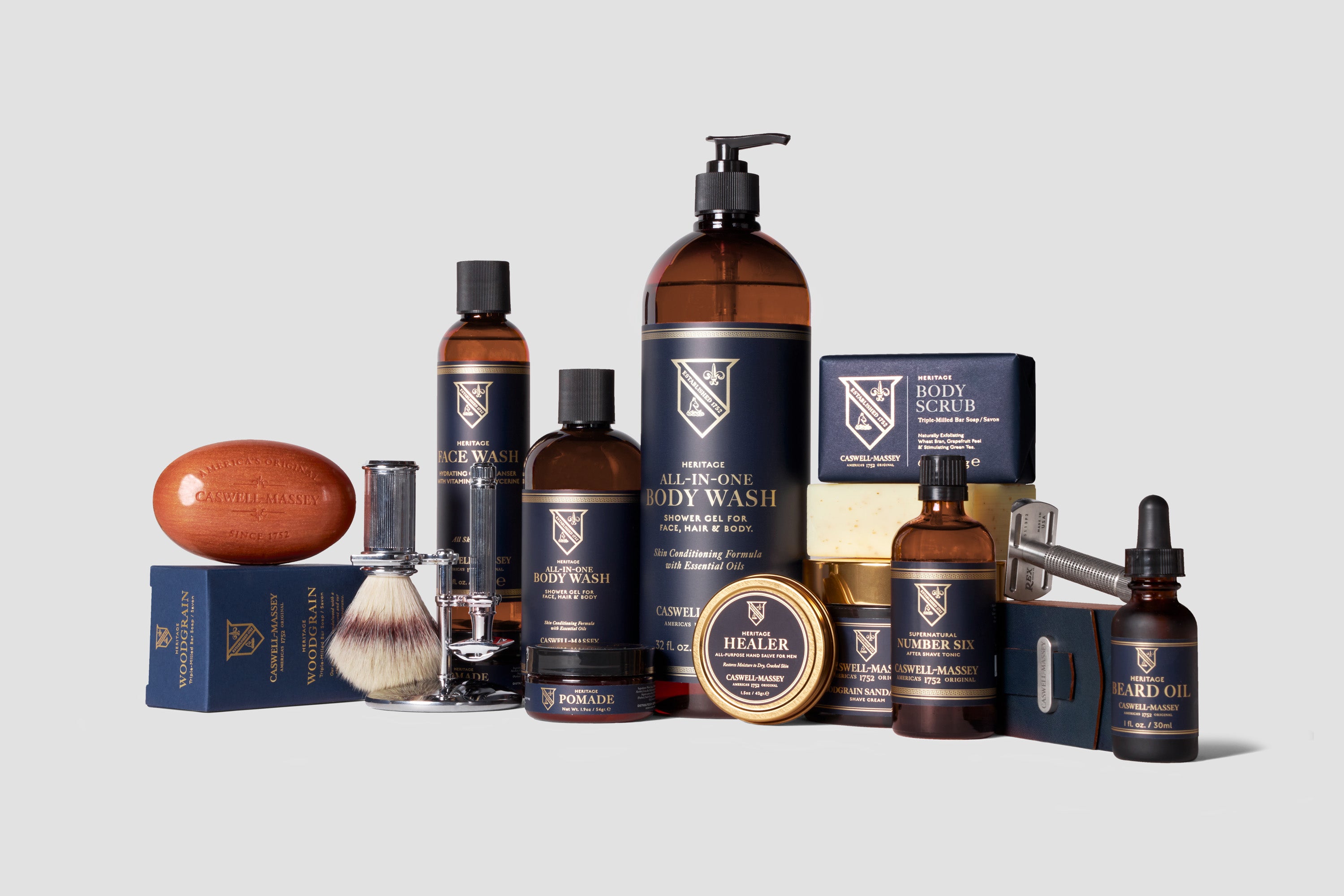 Caswell-Massey Heritage Collection for Men: image shows assortment of men's grooming products including Chrome Shave Set, Woodgrain Sandalwood Bar Soap, Heritage All-in-One Body Wash, Heritage Face Wash, Heritage Face & Beard Oil, Heritage Healer Hand Salve, Heritage Body Scrub Bar Soap, Number Six Shave Cream, and Number Six Aftershave