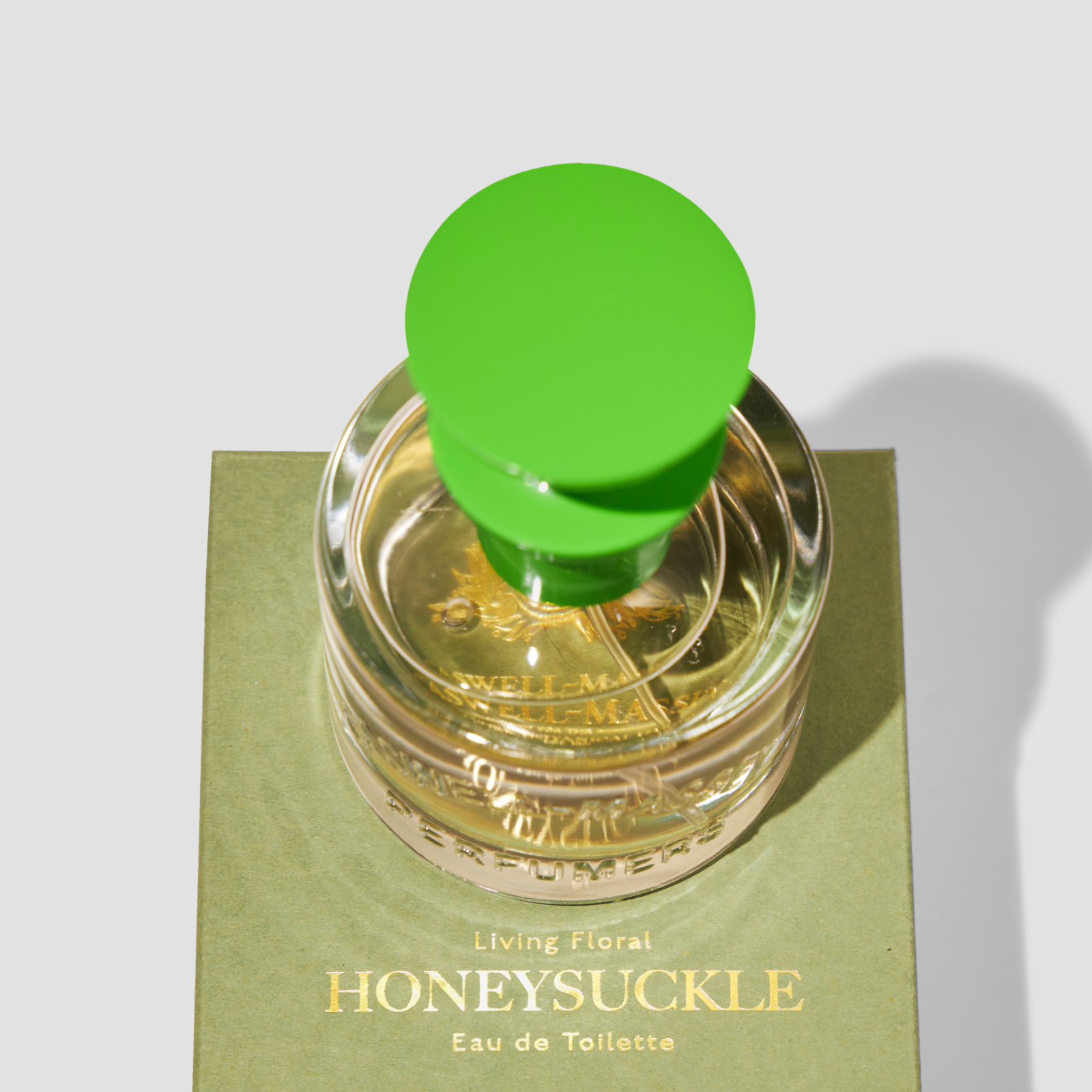 Caswell-Massey Honeysuckle Eau de Toilette for women, full size 60ml bottle on top of outer sage green packaging