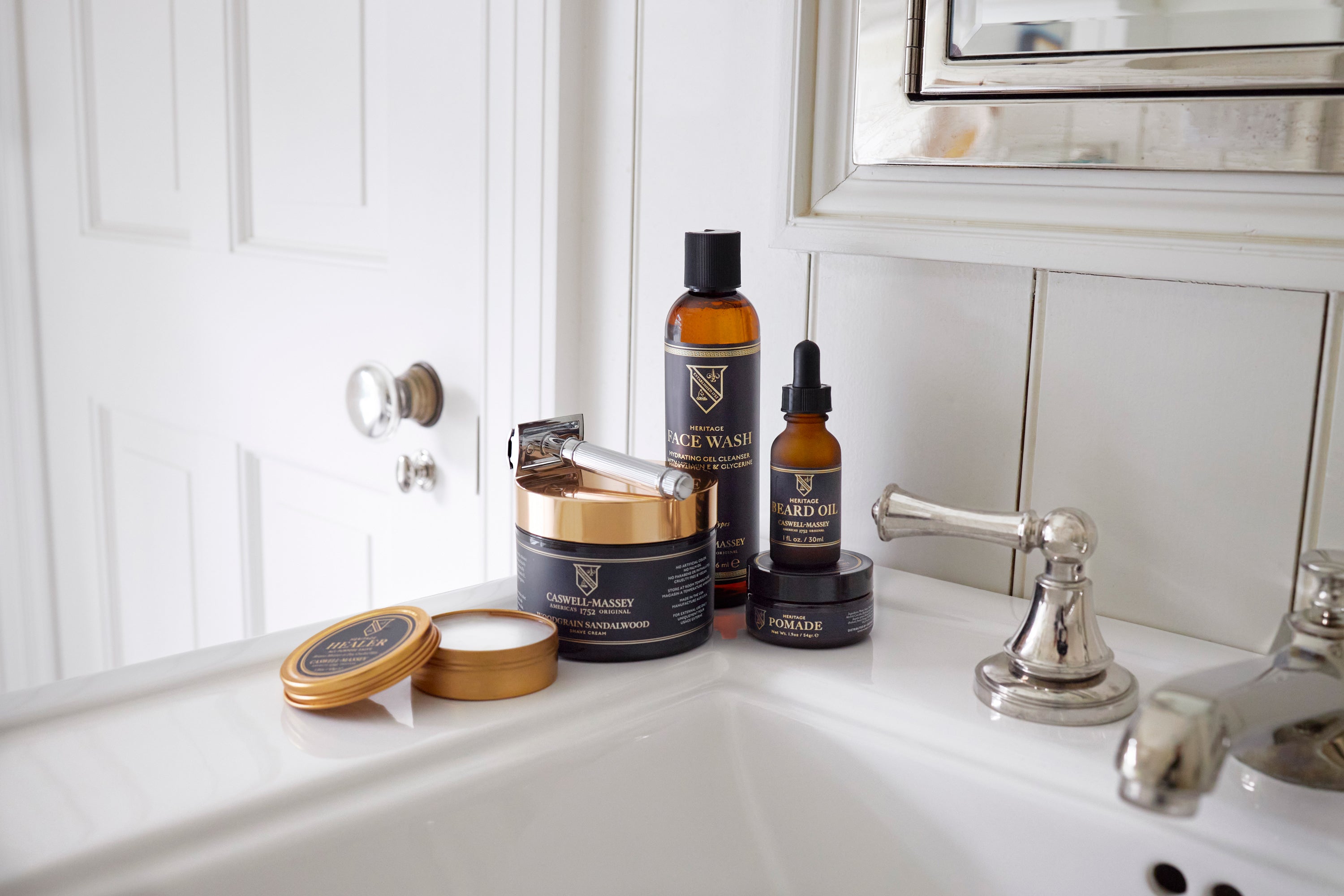 Caswell-Massey's Men's Heritage Collection: shave cream, pomade, beard oil, and hand salve shown on bathroom sink
