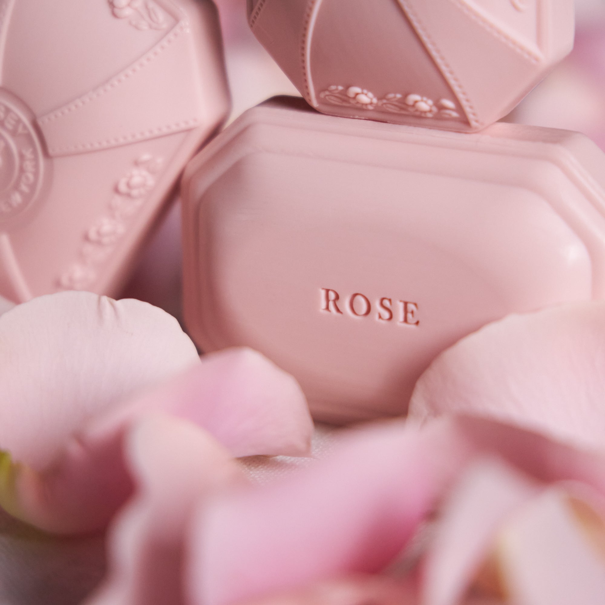 Caswell-Massey Rose Bath Soap: pink soap with "ROSE" imprinted surrounded by pink rose petals