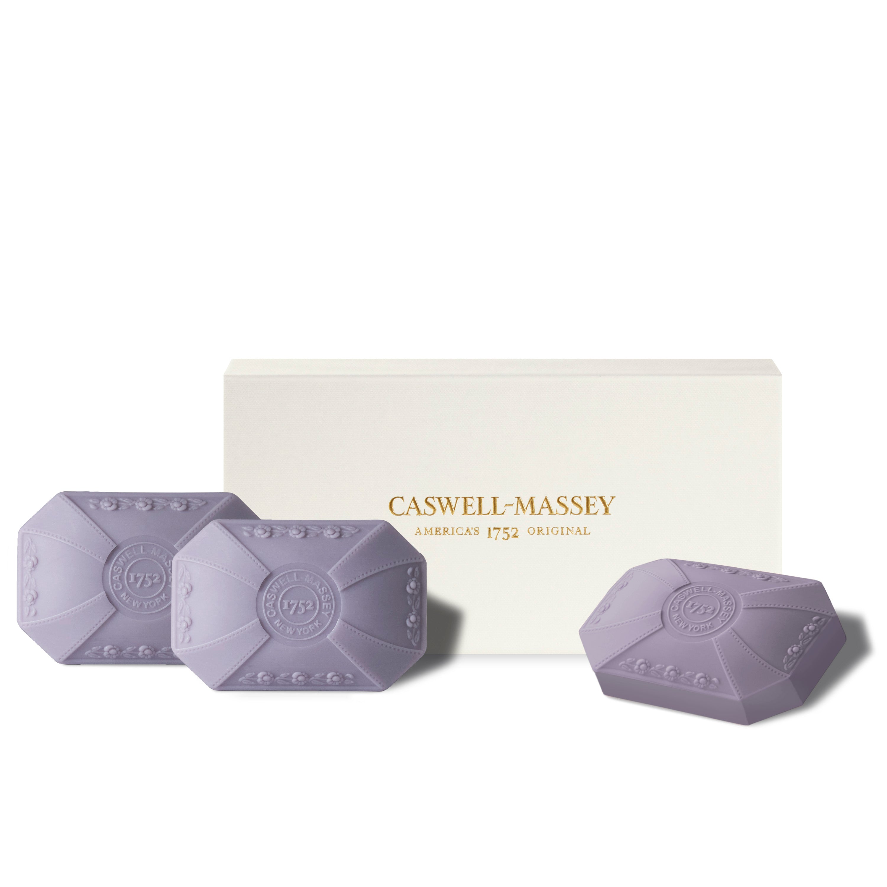 Caswell-Massey Orchid 3-Soap Gift Set shown with gift box alongside soft purple decorative soaps