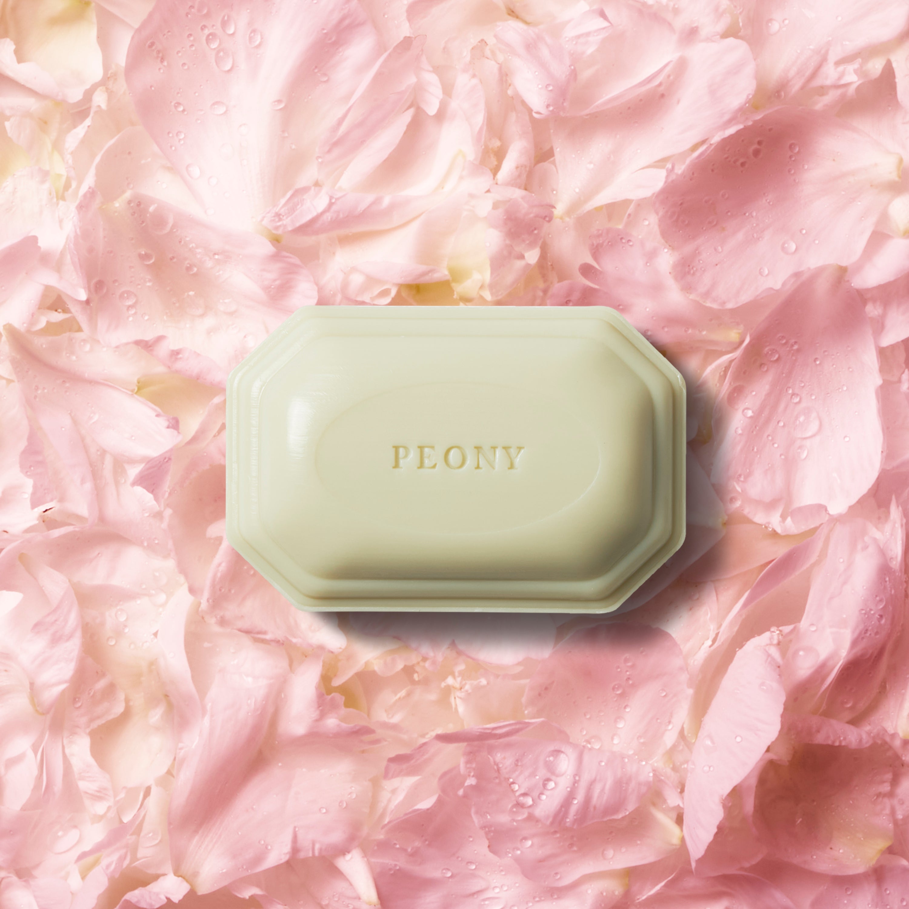 Caswell-Massey Peony Bar Soap shown on bed of soft pink peony petals