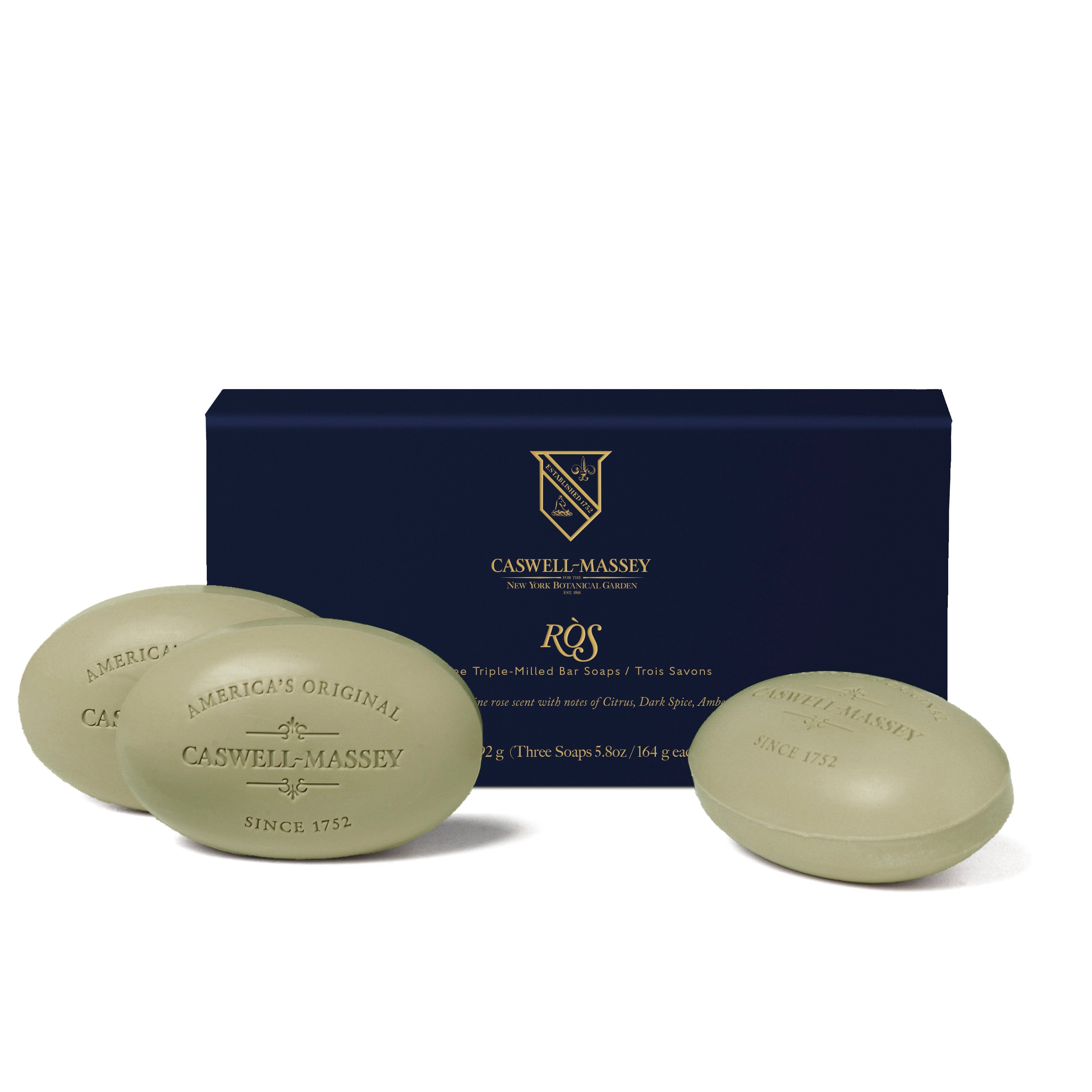 Caswell-Massey RÒS 3-Soap Set shown with navy blue gift box alongside sage green bath soaps