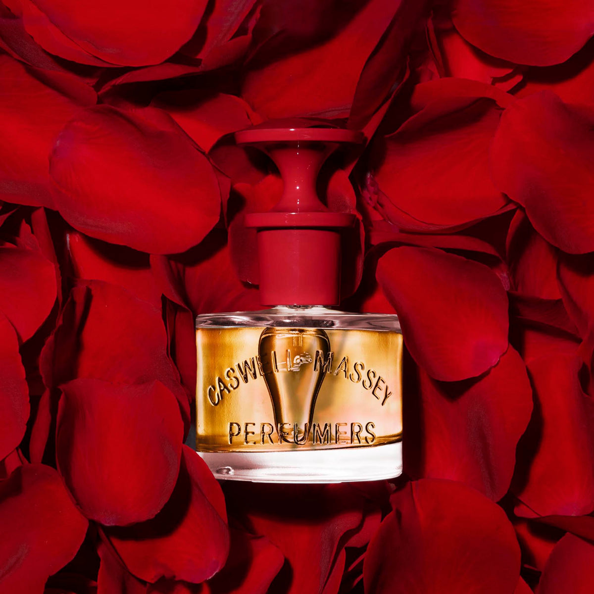 Caswell-Massey Marem Perfume shown in bed of crimson red roses