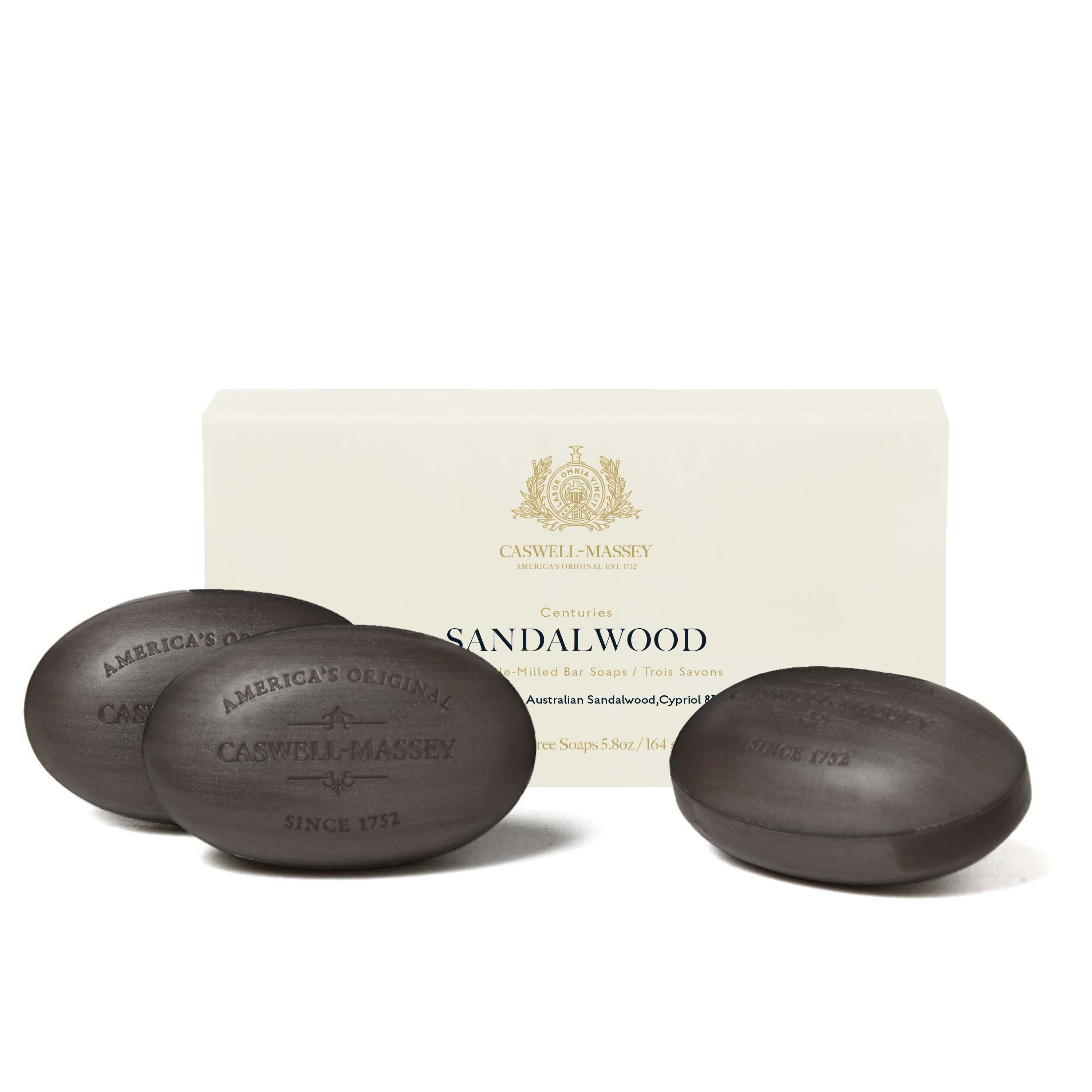 Caswell-Massey® Centuries Sandalwood 3-Soap Set shown next to cream gift box alongside grey bars of soap