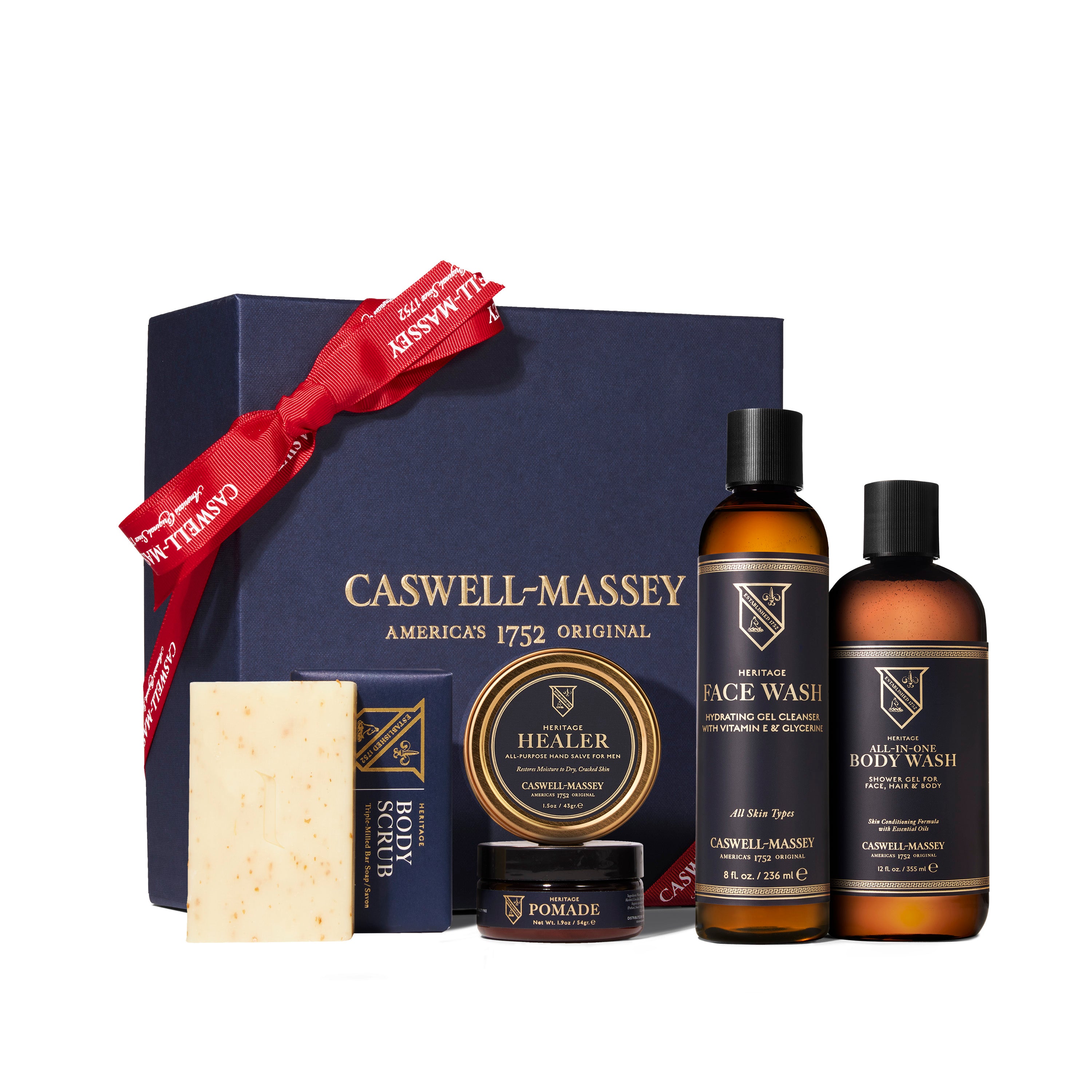 Men's Caswell-Massey Heritage Grooming Gift Set: Body Scrub Soap, Healer Hand Salve, Medium Fiber Hair Pomade, Face Wash, and All-in-One Body Wash included in navy gift box with red ribbon