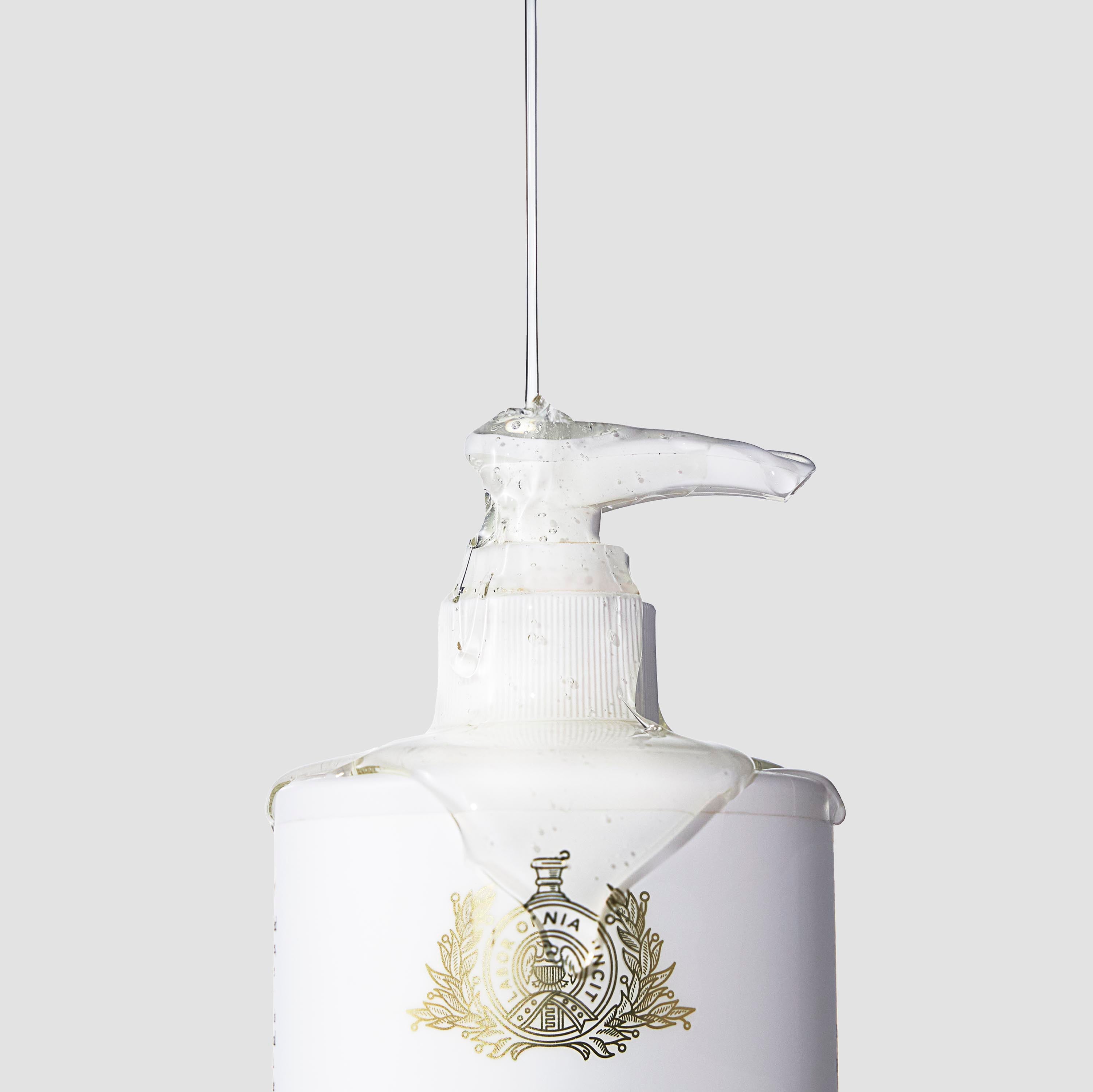 Caswell-Massey Rosewater Hand Wash in a 10 oz. pump bottle shown with liquid soap dripping