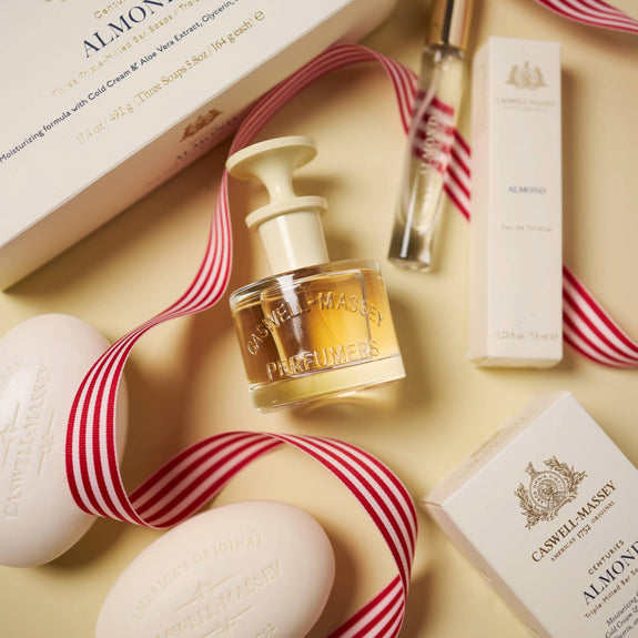a group of white soaps and a bottle of perfume