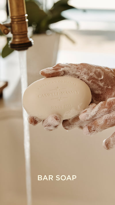 a person washing hands with soap