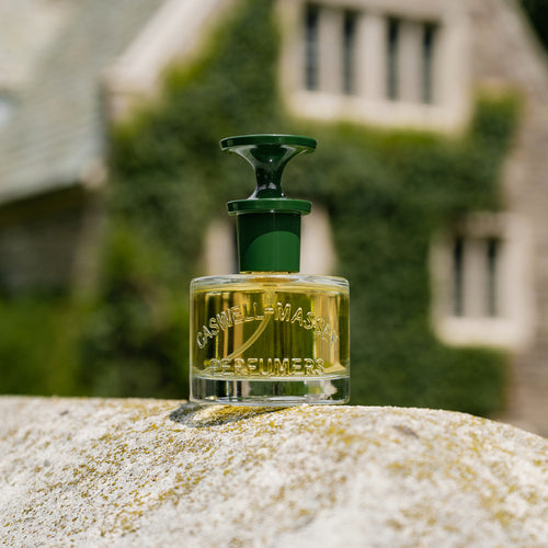 a bottle of perfume on a rock