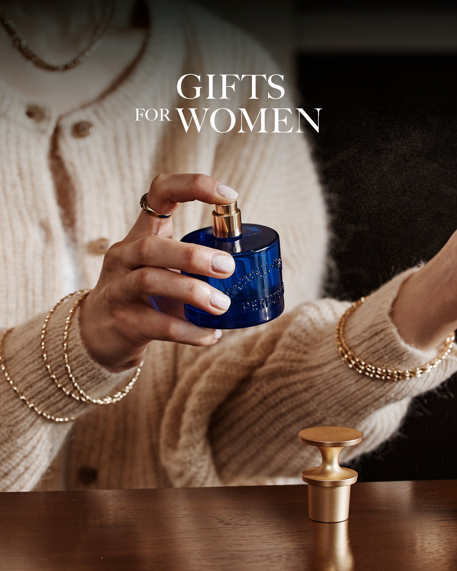Caswell-Massey Gifts for Women: Woman spritzing bottle of Elixir of Love Eau de Toilette