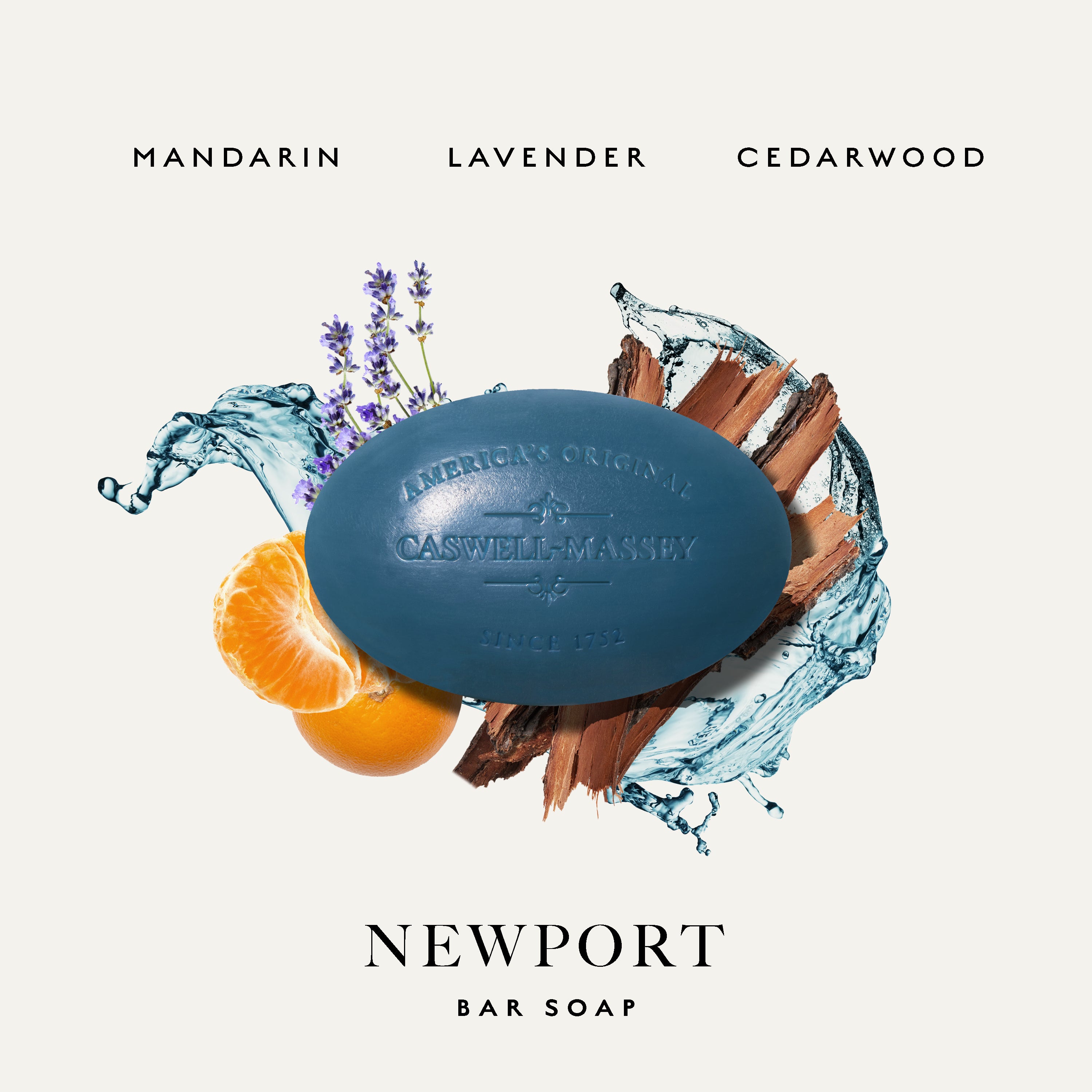 A Caswell-Massey Newport bar soap product graphic on a light warm-gray background. A dark blue oval bar of soap is centered, with water splash graphics, purple lavender stems, orange slices, and brown wood pieces around it.