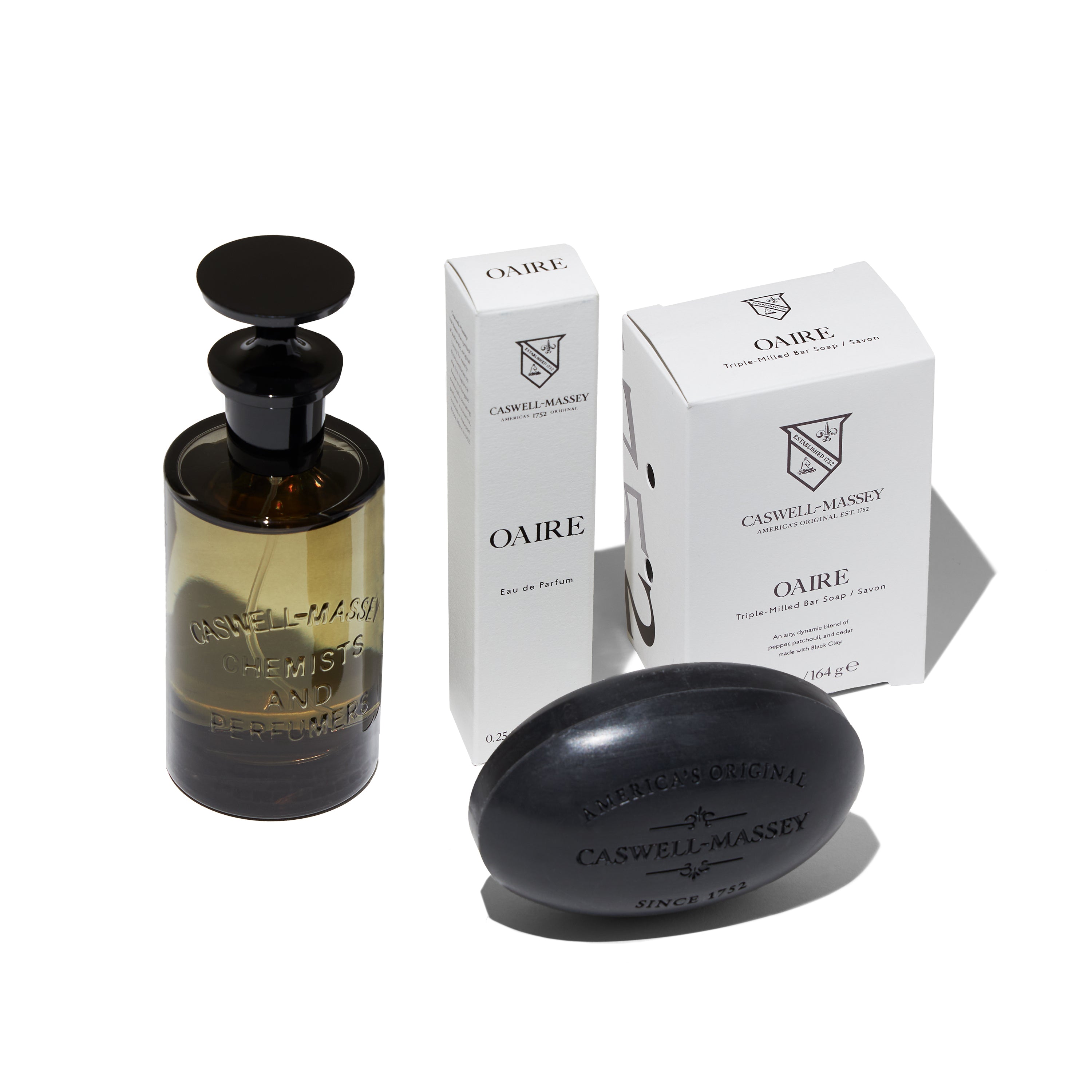 Caswell-Massey Oaire Eau de Parfum showing full-size 100ml, travel-size 100ml, and Oaire Bar Soap