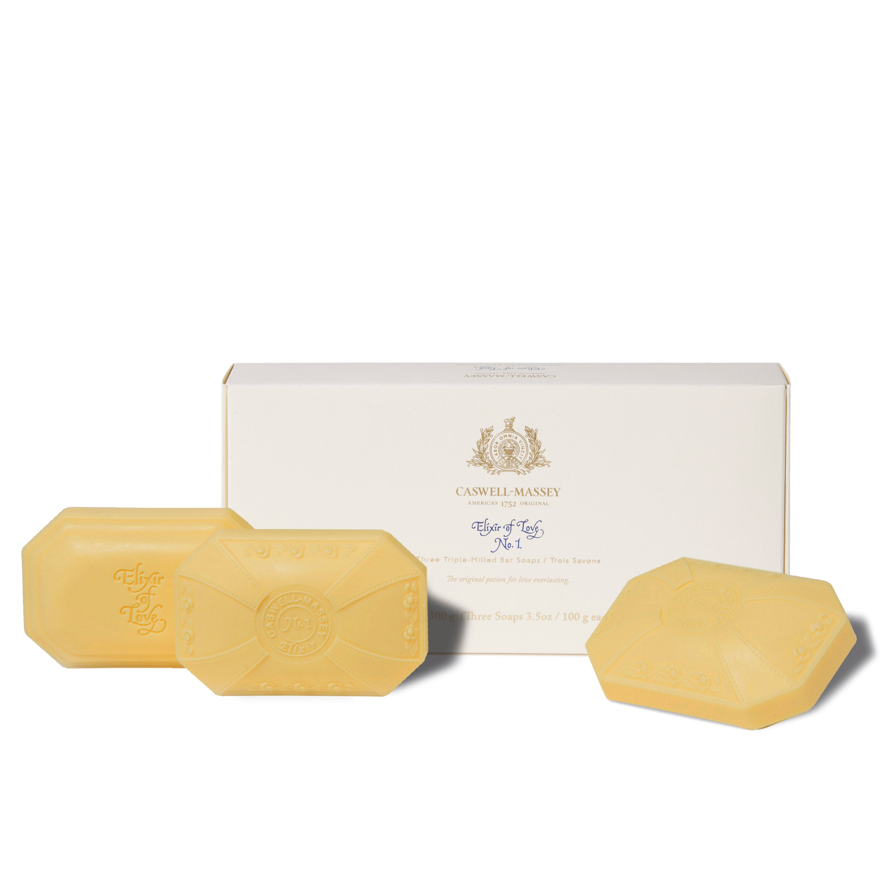 Caswell-Massey Elixir of Love Luxury 3-Soap Gift Set shown with gift box alongside cream natural colored decorative bar soaps