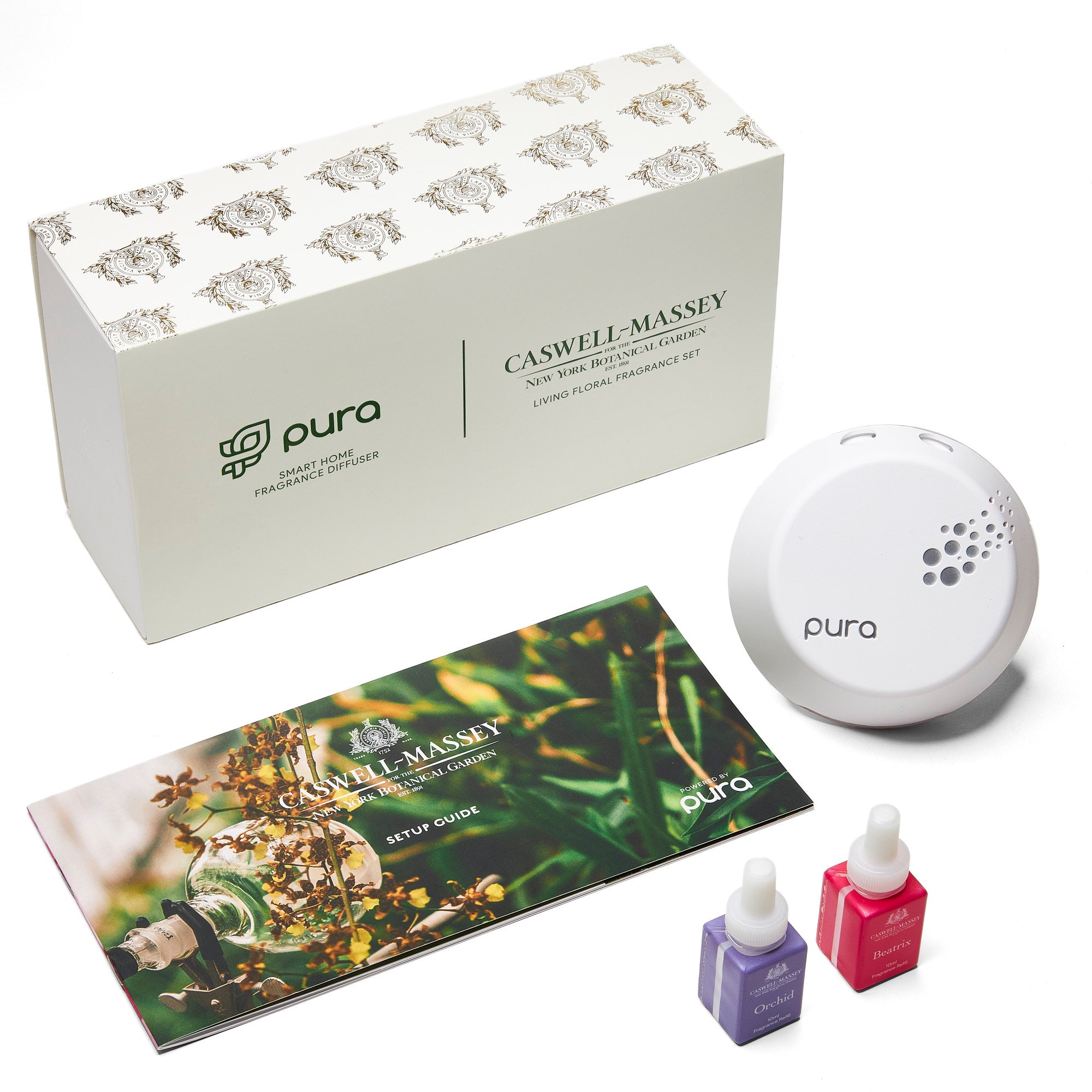 NYBG Pura Living Floral Fragrance Set: shown with user guide, pura plug-in device, and two fragrance vials of Orchid and Honeysuckle